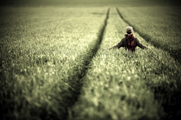 Man walking through field